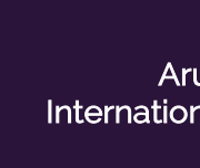 The DWC Logo on a purple background that reads "Aruna Jain International Travel Grant"