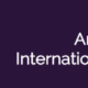 The DWC Logo on a purple background that reads "Aruna Jain International Travel Grant"